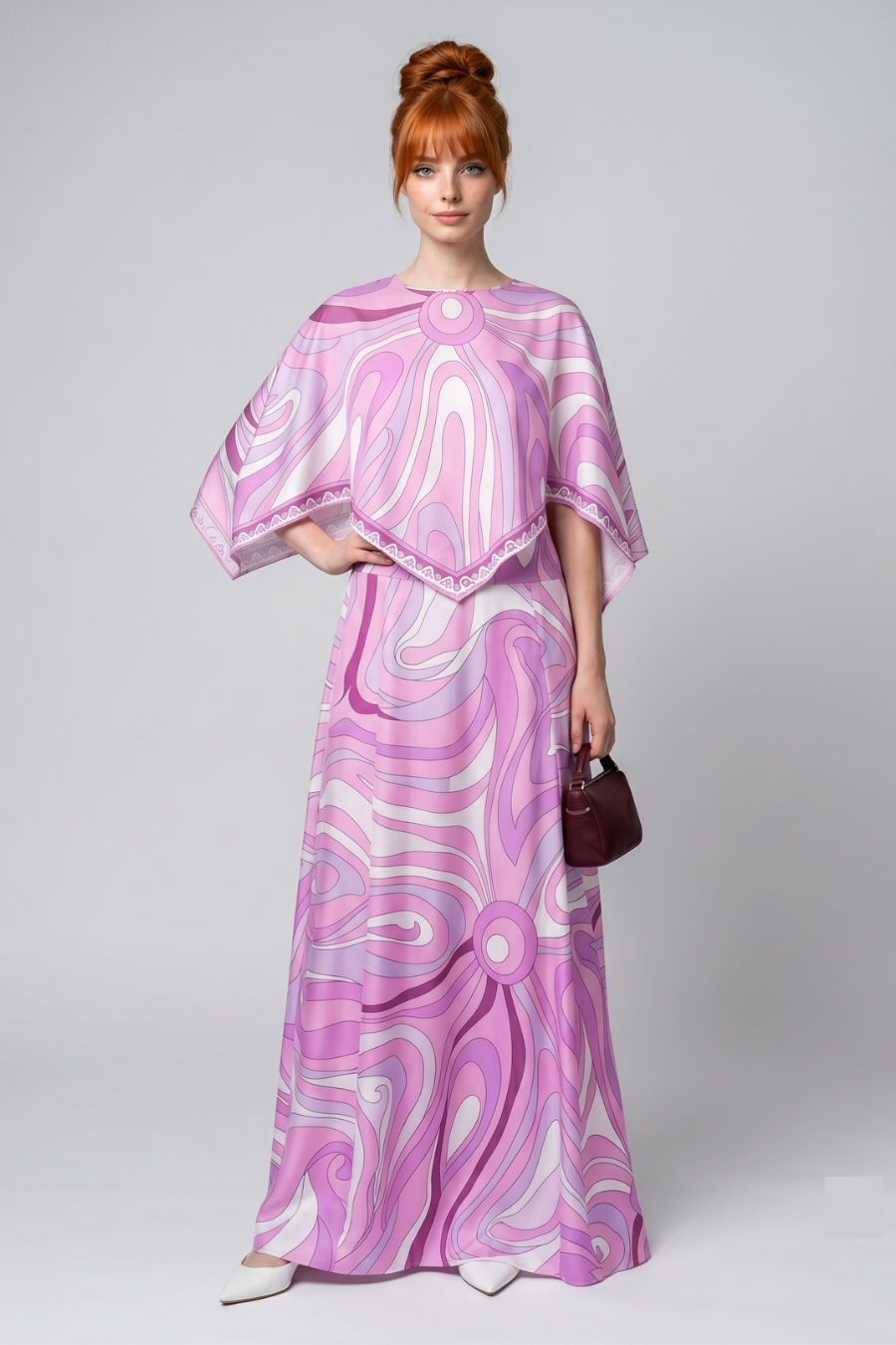 Woman wearing a pink and white patterned dress on a plain background