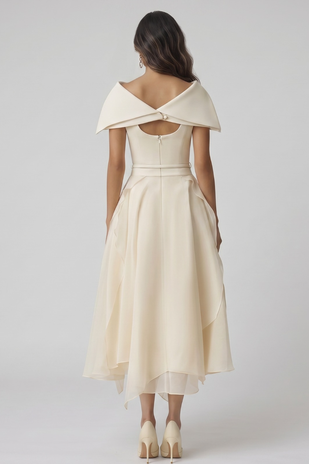 Woman wearing a beige off-shoulder dress with a plain background, bridal dress