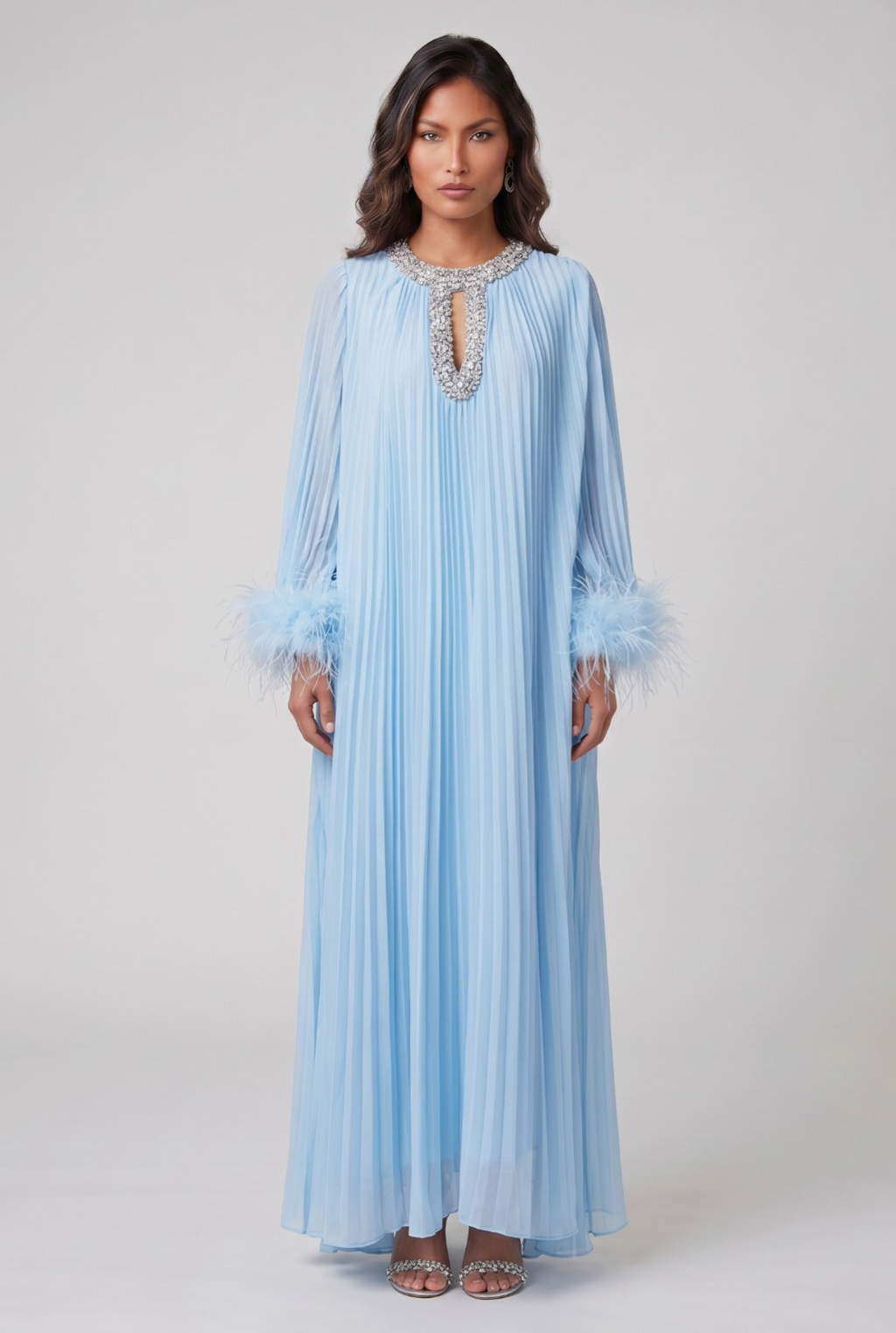 Woman wearing a light blue dress with lace details on a white background