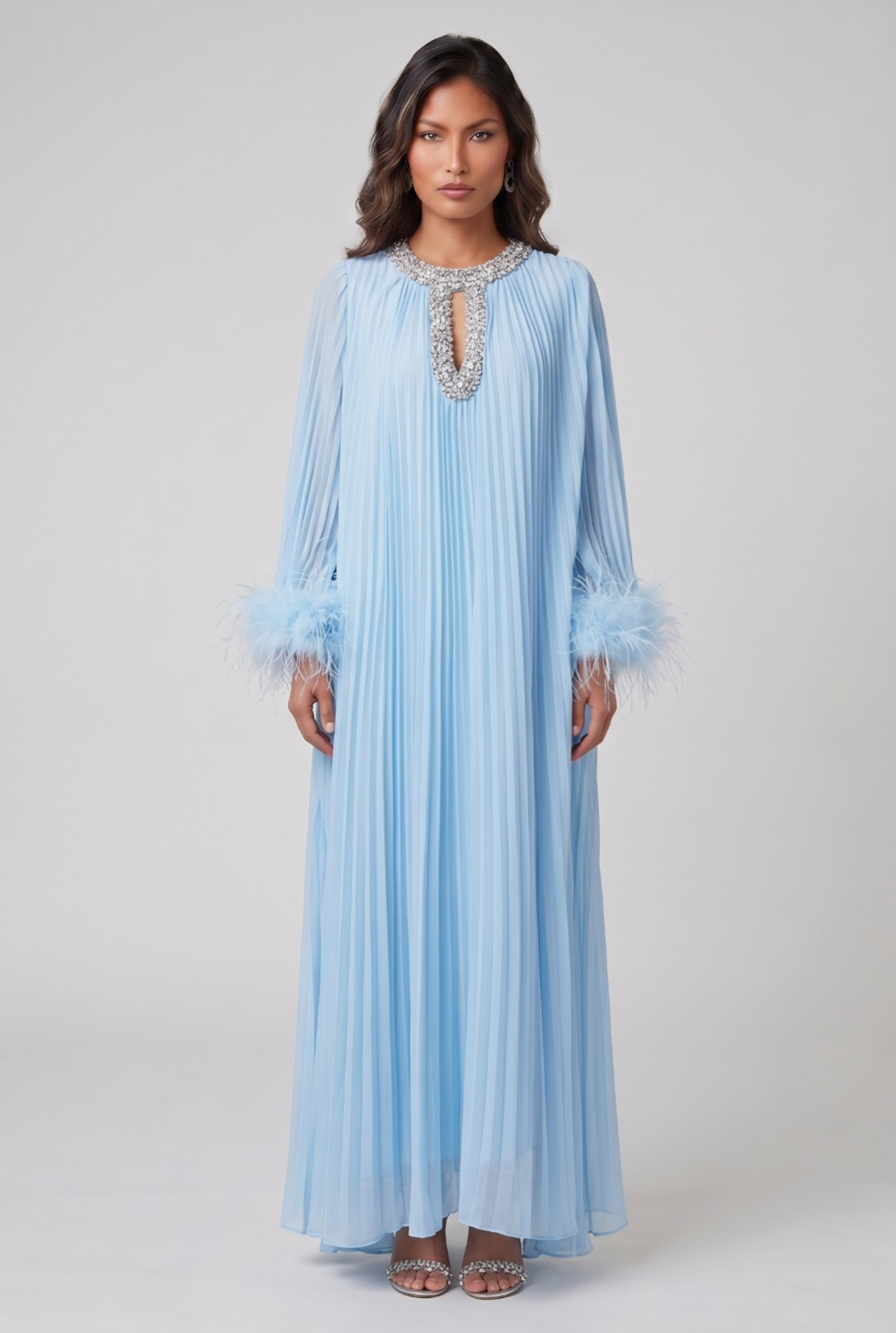 Woman wearing a light blue dress with lace details on a white background