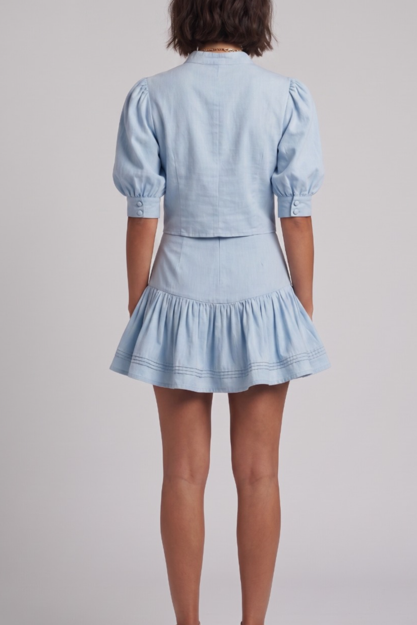 Light blue dress with puff sleeves on a plain background