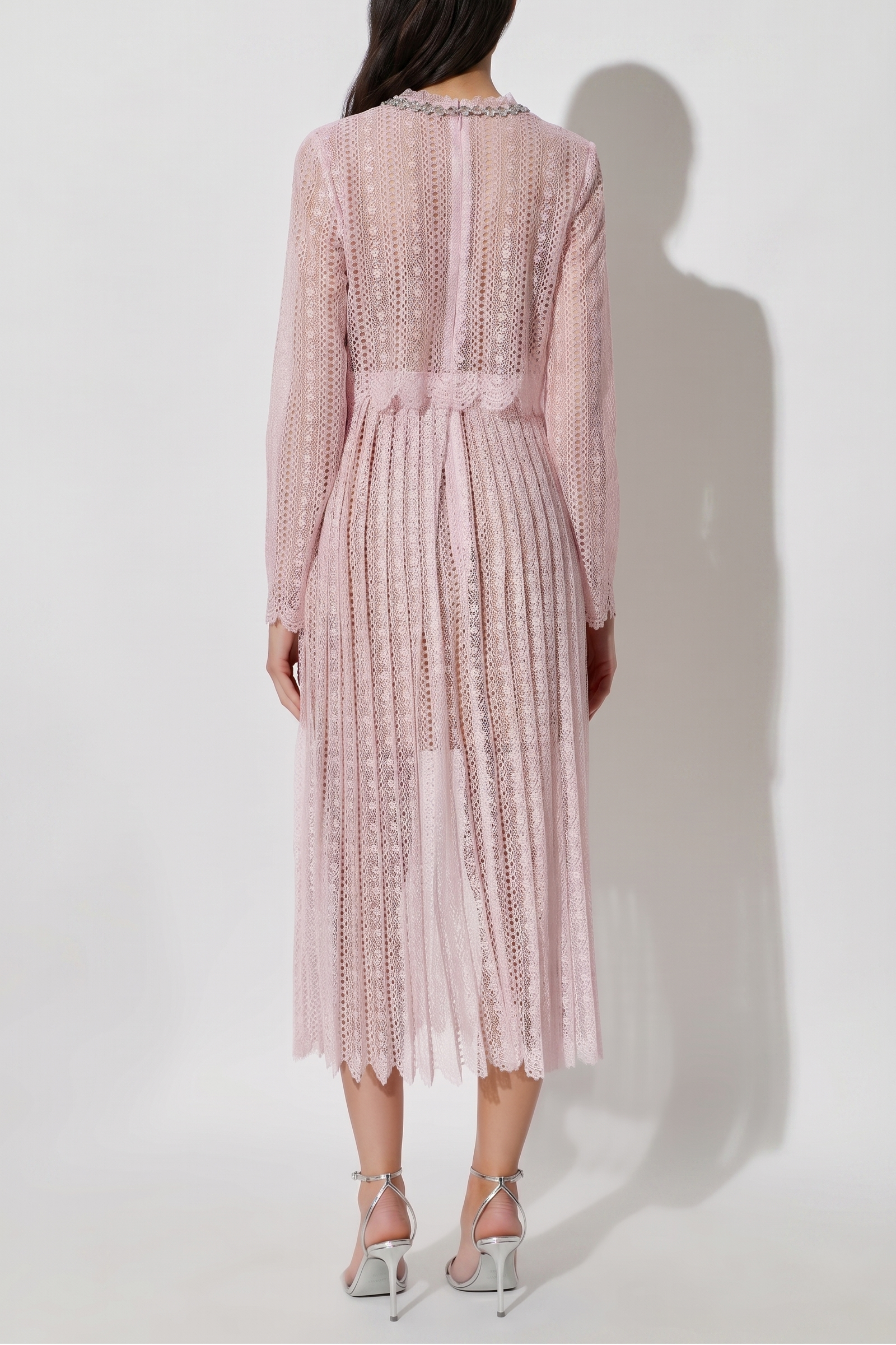 Woman wearing a pink dress with a white background