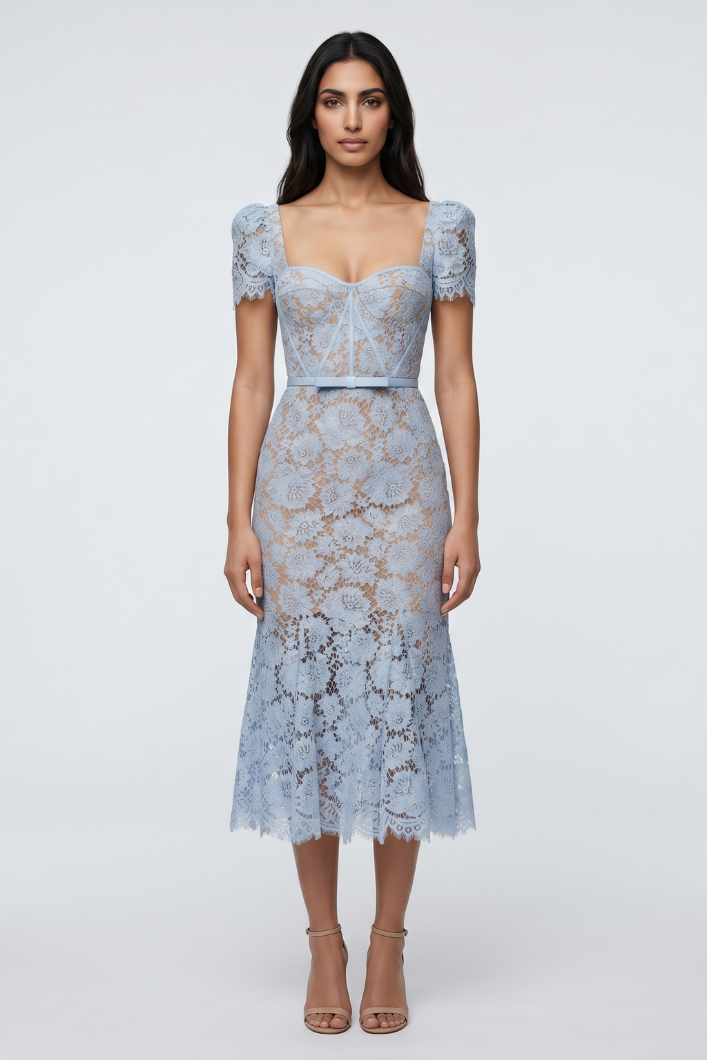 Woman wearing a light blue lace dress on a white background
