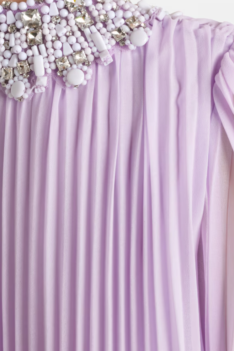 Lavender backdrop with decorative beads and flowers