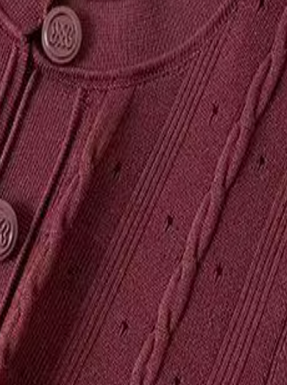 Close-up of a burgundy knitted cardigan with button details