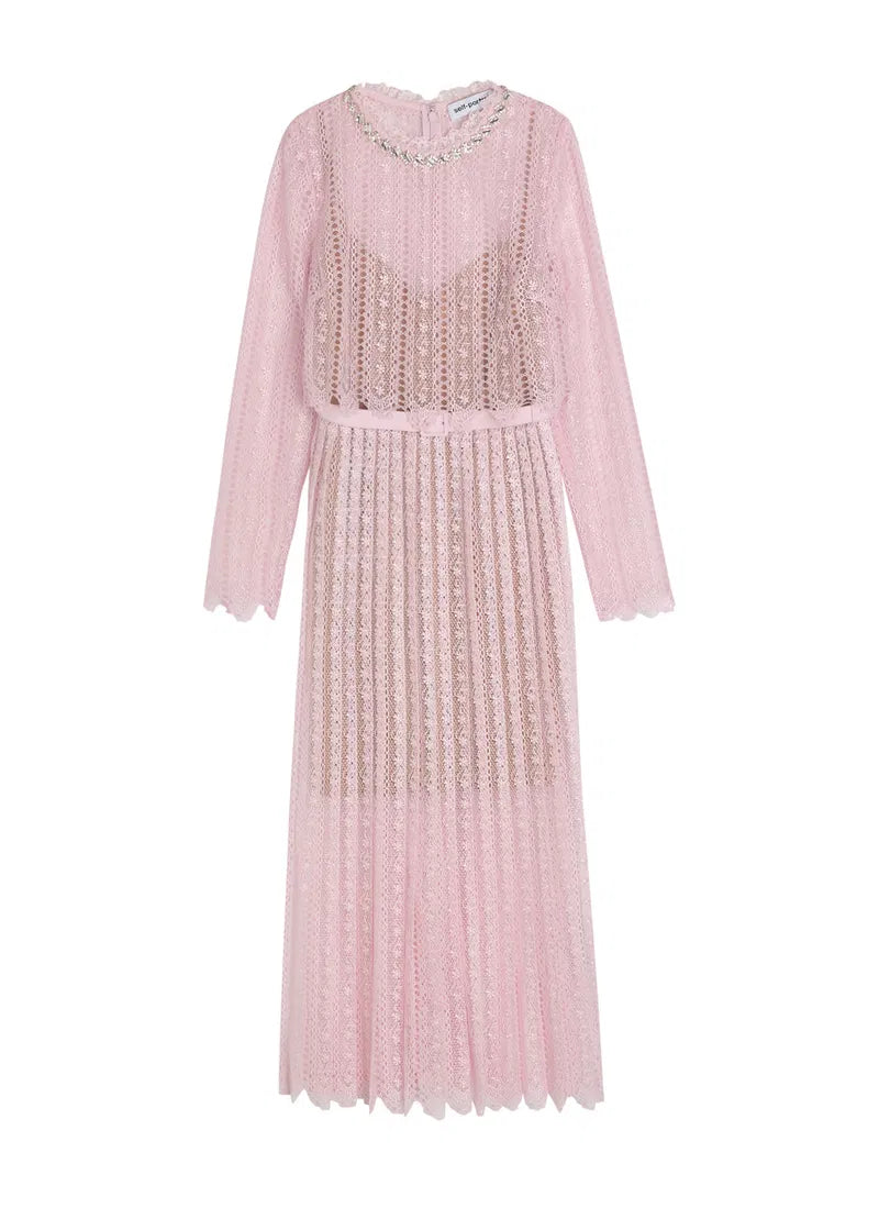 Pink dress with intricate detailing on a white background